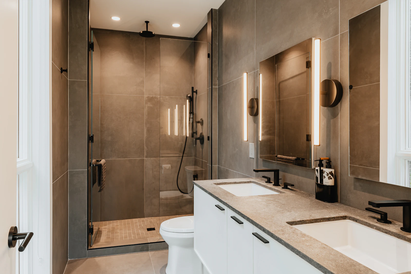Finished bathroom with a walk-in shower, toilet and double vanity